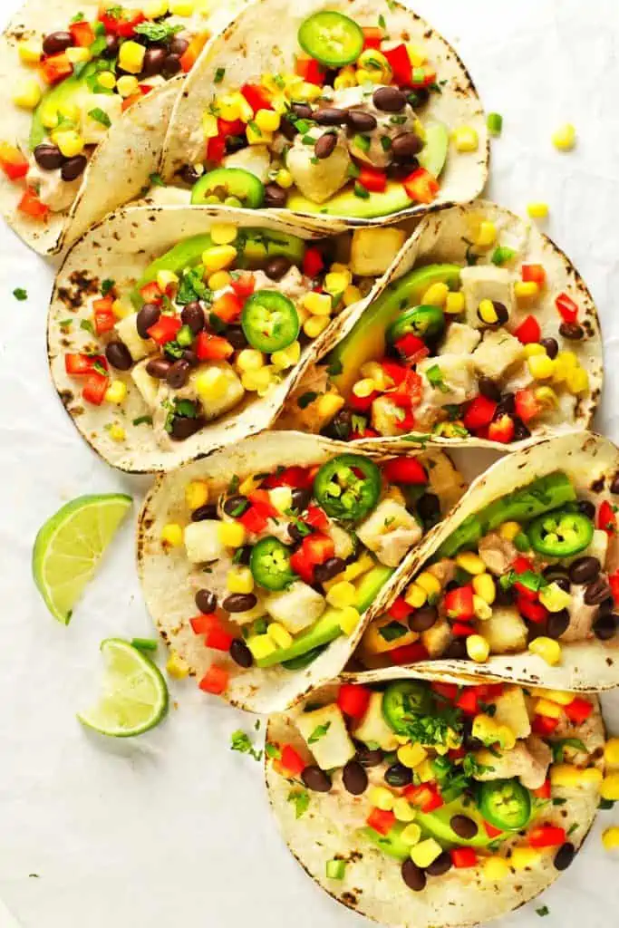 Spicy tofu tacos with lime wedges.