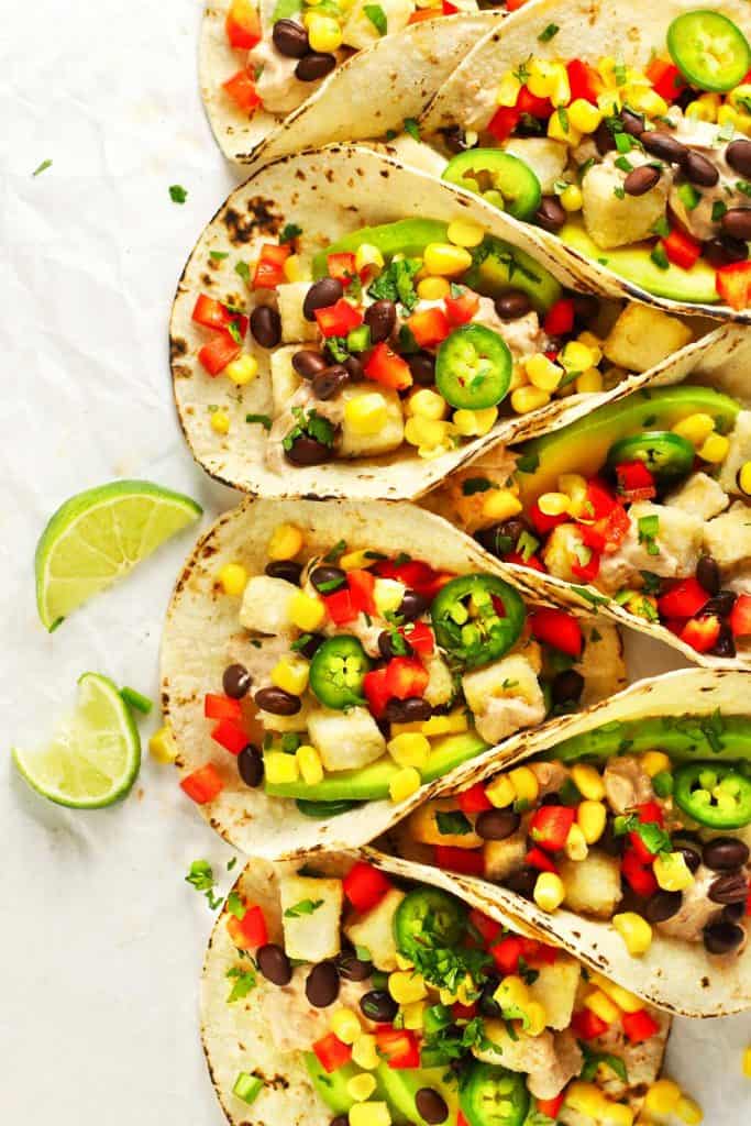Spicy tofu tacos with lime wedges. 
