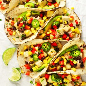Spicy tofu tacos with lime wedges.