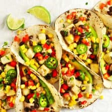 Spicy tofu tacos with lime wedges.