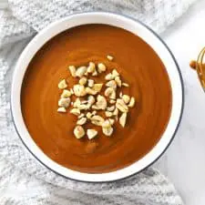 Easy spicy peanut sauce in round dish with whisk.