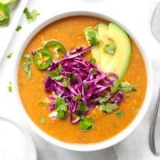 Healthy chicken tortilla soup with fresh toppings.