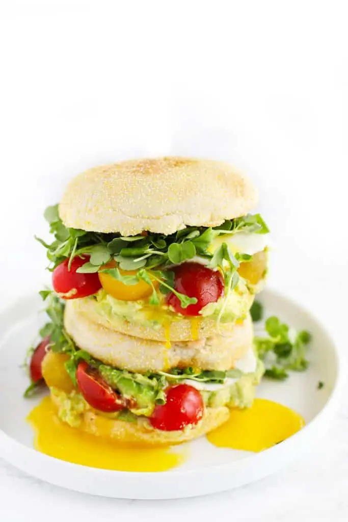 Easy breakfast sandwiches on white plate.