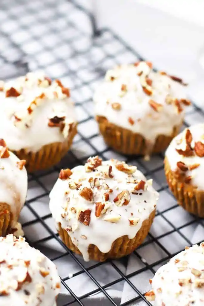 Healthy carrot cake muffins on cooling rack.