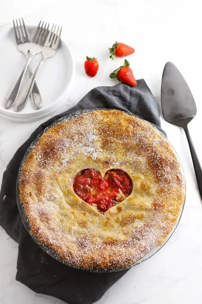 Strawberry rhubarb pie with grey napkin.