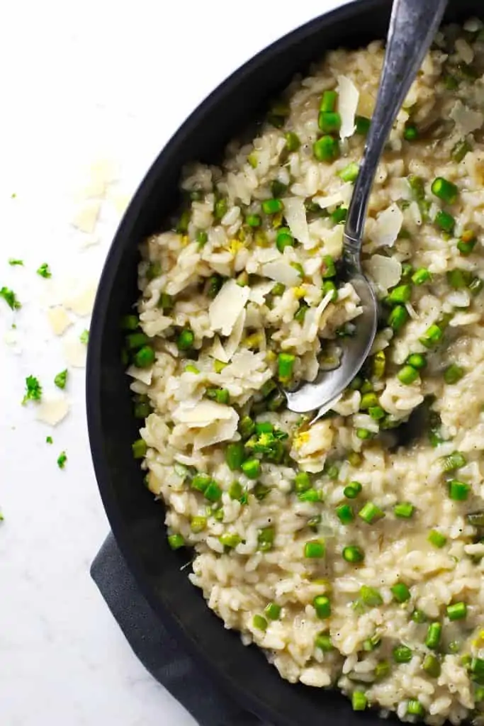 Lemon asparagus risotto in pan with spoon.
