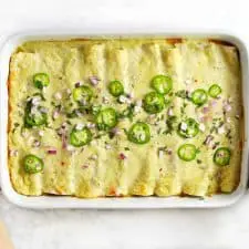 Vegetarian black bean enchiladas in a white dish.