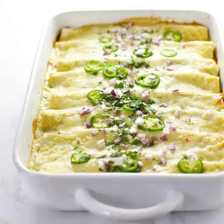 Vegetarian black bean enchiladas in a white dish.