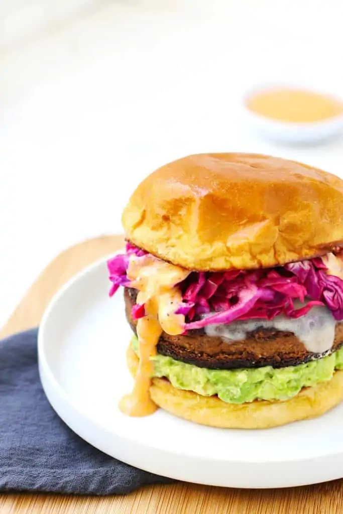 Closeup of black bean veggie burger on white plate.