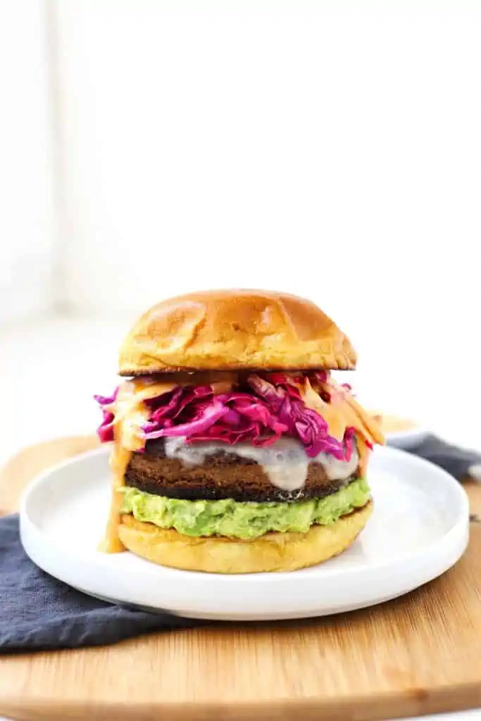 Black bean veggie burger on white plate.