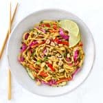 Thai noodle salad in grey bowl with chopsticks.