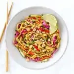 Thai noodle salad in grey bowl with chopsticks.