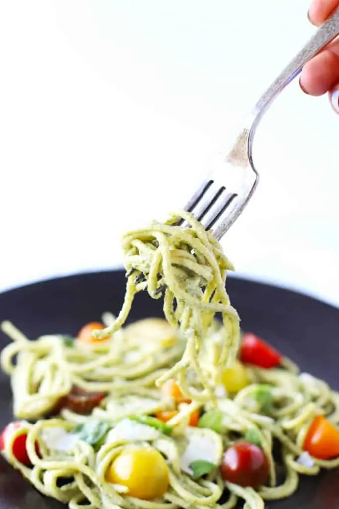 Creamy basil cashew pasta on a fork.