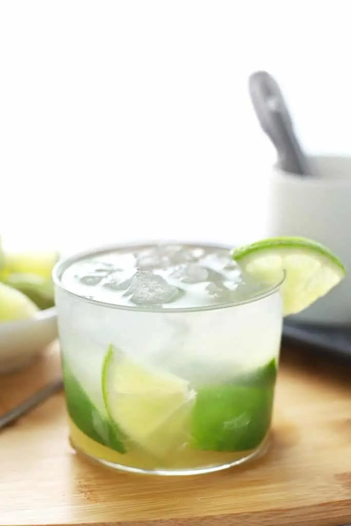 Caipirinha in glass on cutting board. 