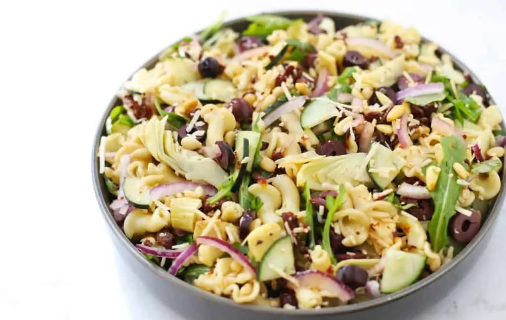 Mediterranean pasta salad in grey bowl.