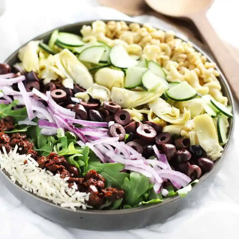 Mediterranean pasta salad in grey bowl before being tossed.