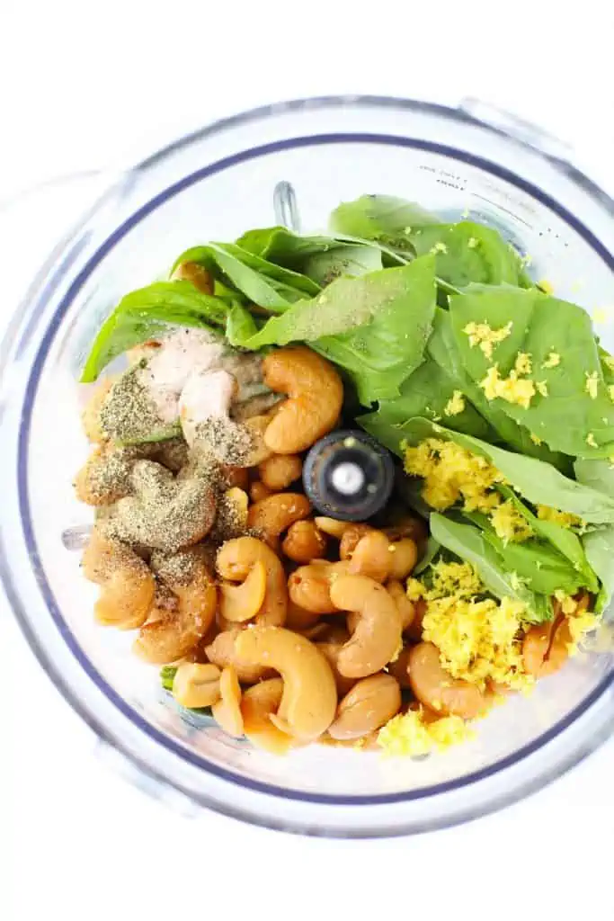 Ingredients for lemon basil cashew sauce in food processor.