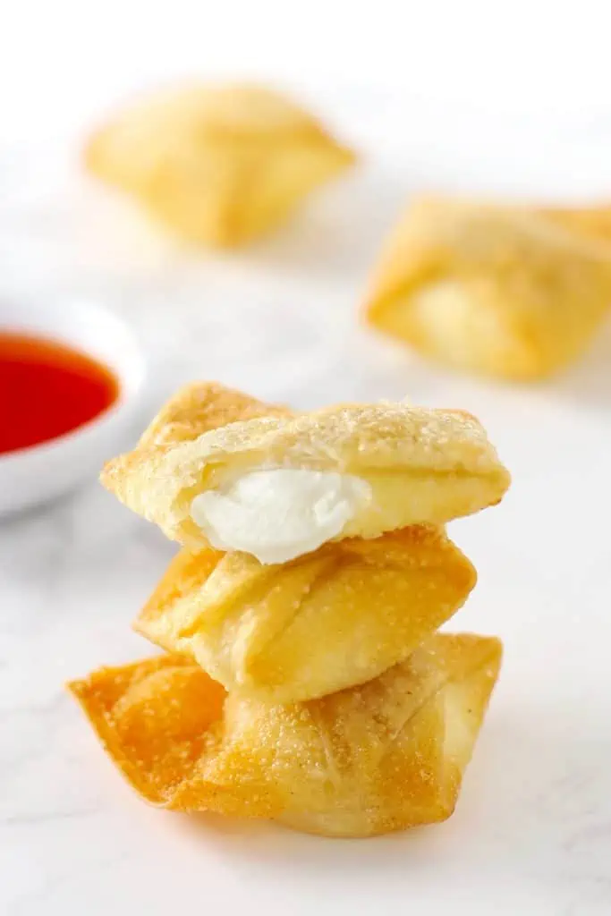 Cream cheese wontons stacked on top of each other. 