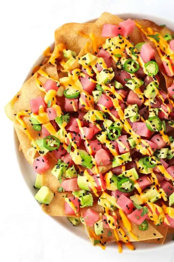 Spicy ahi tuna wonton nachos on white plate.