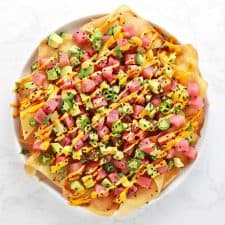 Spicy ahi tuna wonton nachos on white plate.