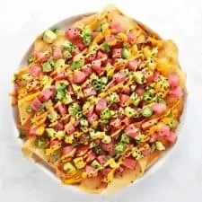 Spicy ahi tuna wonton nachos on white plate.