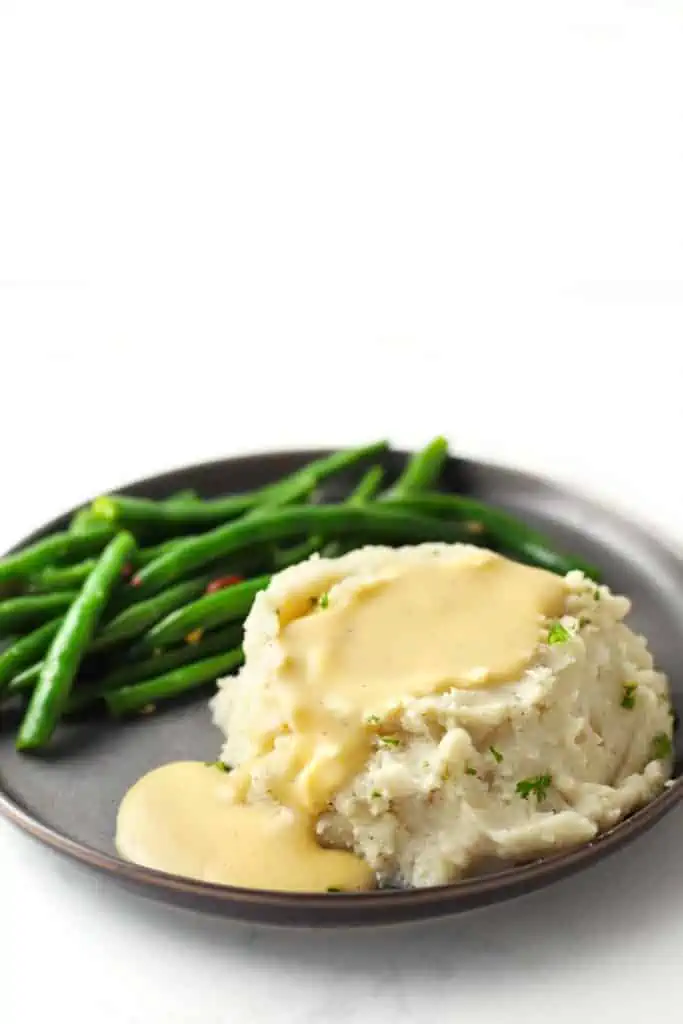 Gravy overflowing mashed potatoes.