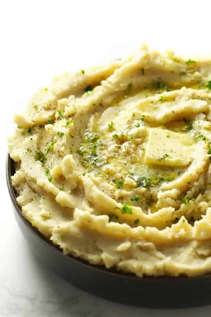 Mashed potatoes in grey bowl.