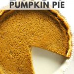 Easy pumpkin pie in white dish with piece missing.
