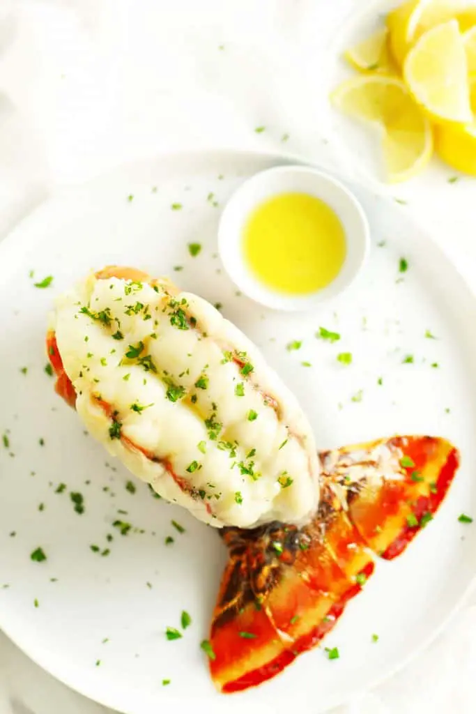 Baked lobster tail on white plate. 