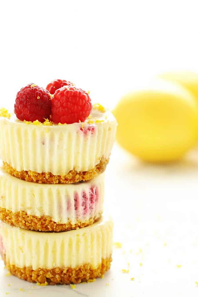 Stack of three raspberry lemon mini cheesecakes. 