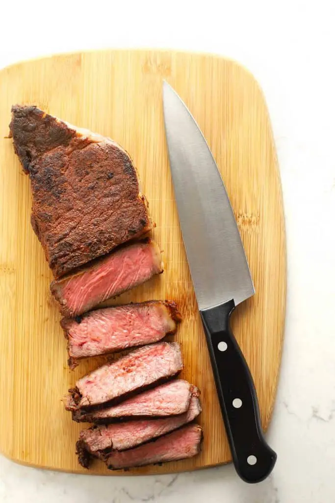 Sliced sous vide steak on a cutting board.