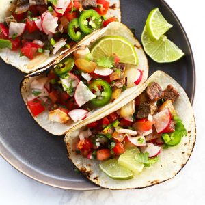 Street tacos with lime wedges