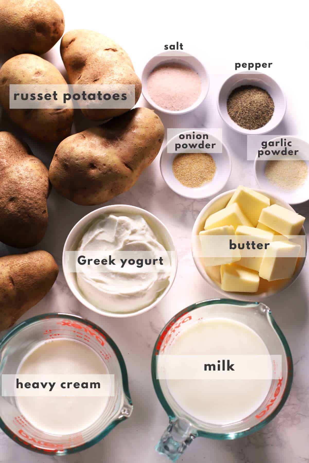 Mashed potato ingredients on marble surface. 