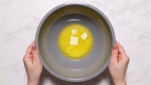 Partially melted butter in large bowl.