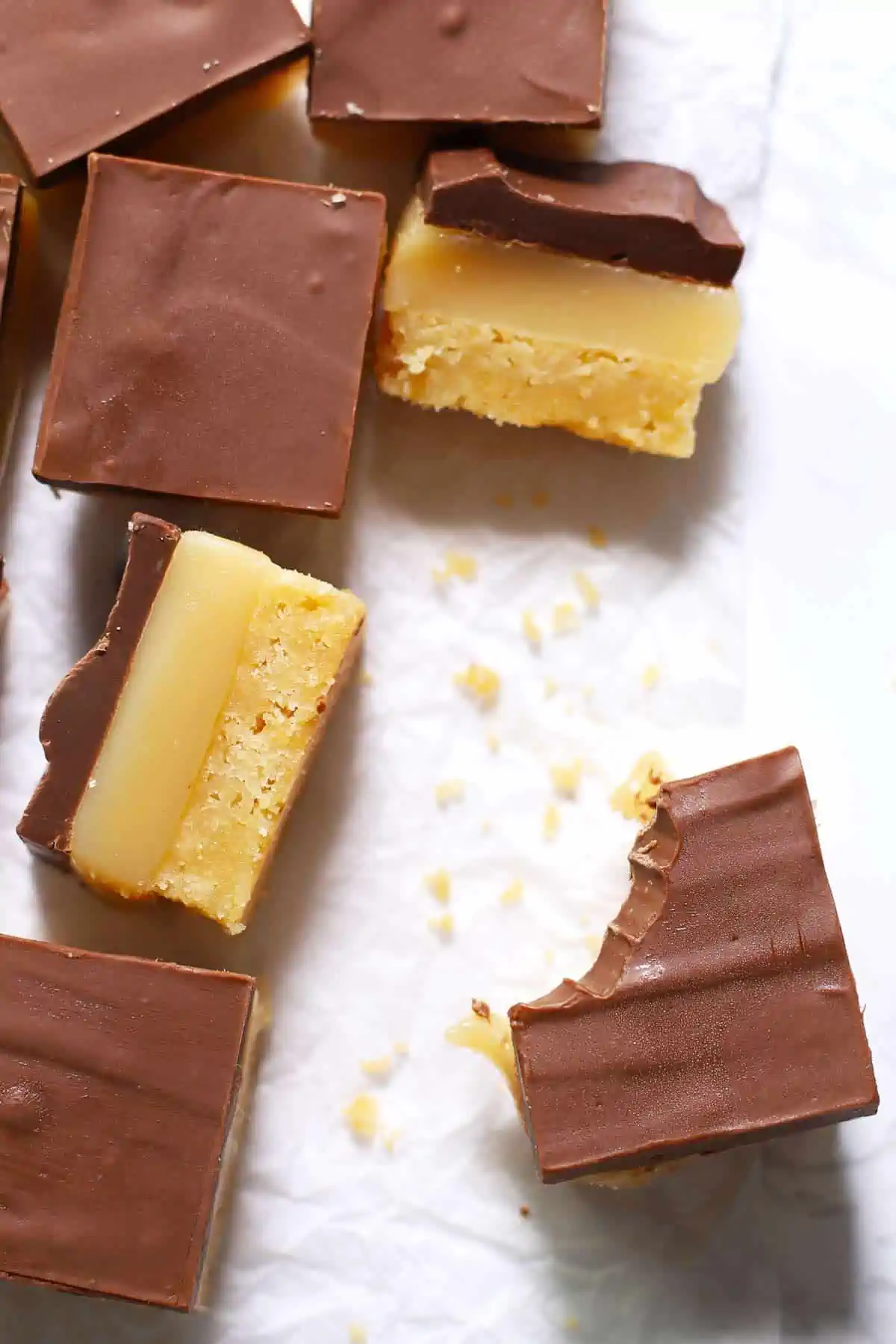 Chocolate caramel cookie bar with a bite taken out of it. 