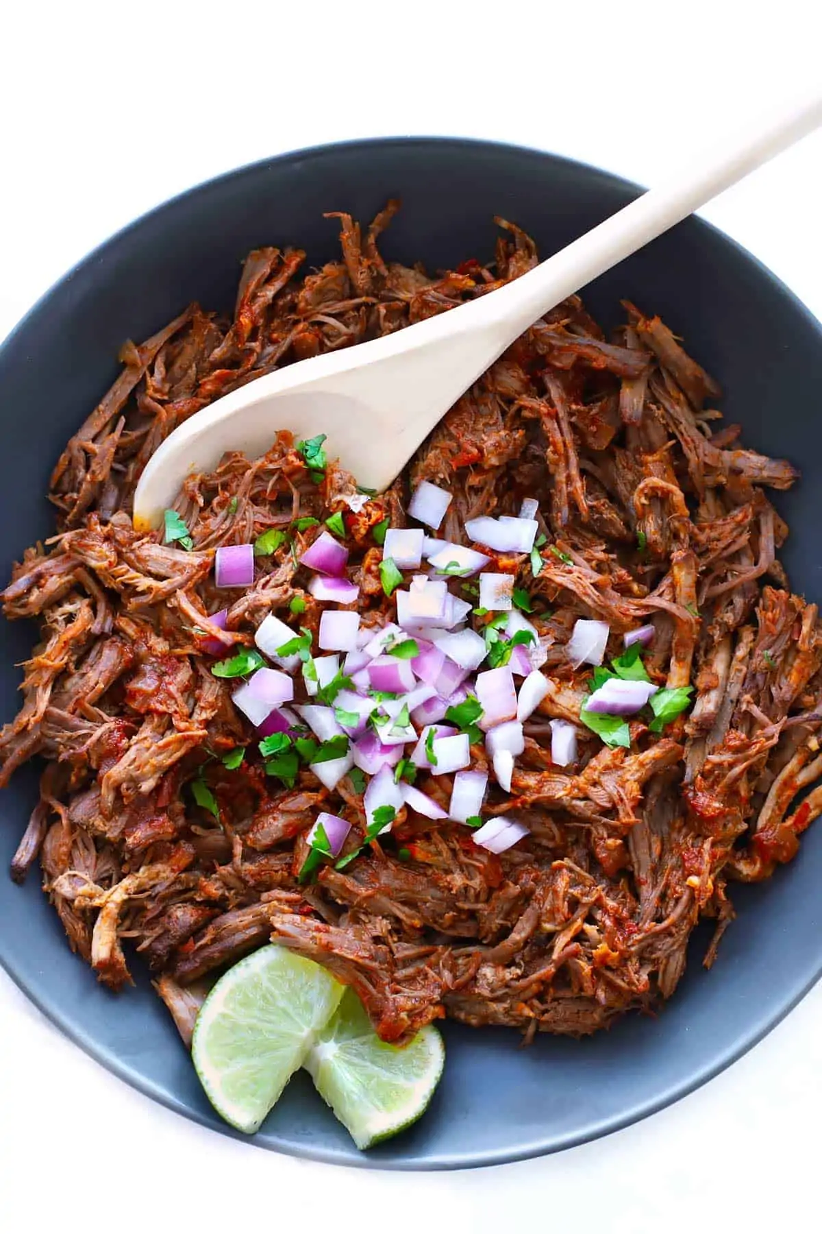 Shredded Birria de res in a grey bowl. 