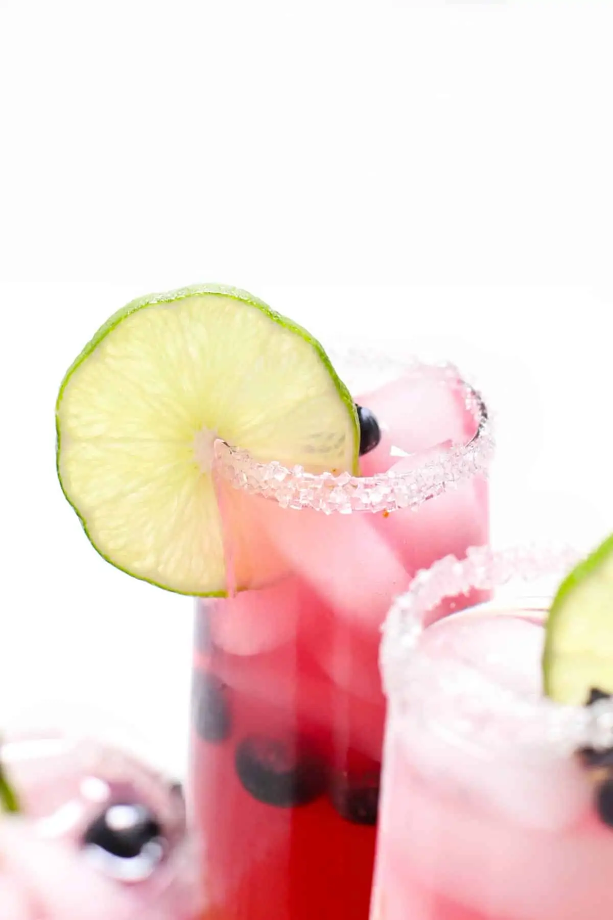 Close-up view of a blueberry margarita over ice. 