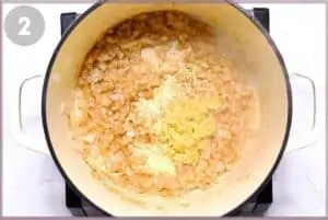 Onions and garlic being sautéed in pot.