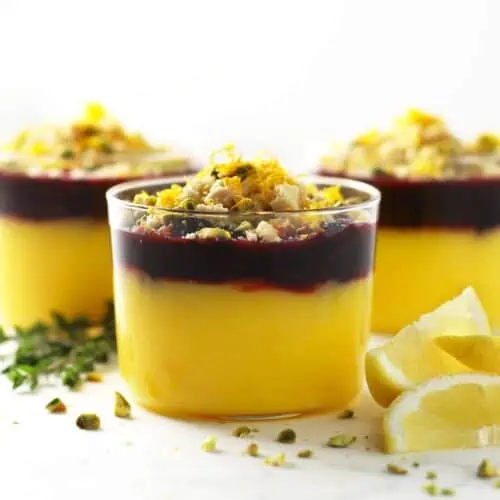 Lemon curd topped with cherry compote in three glasses