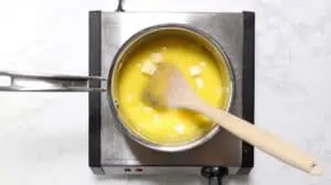 Cubed butter in a pot of lemon curd.