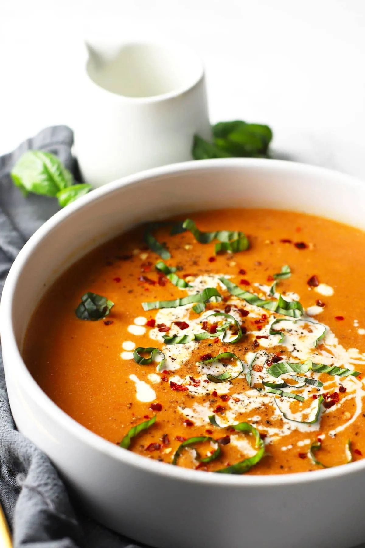 Roasted tomato soup in a white bowl. 