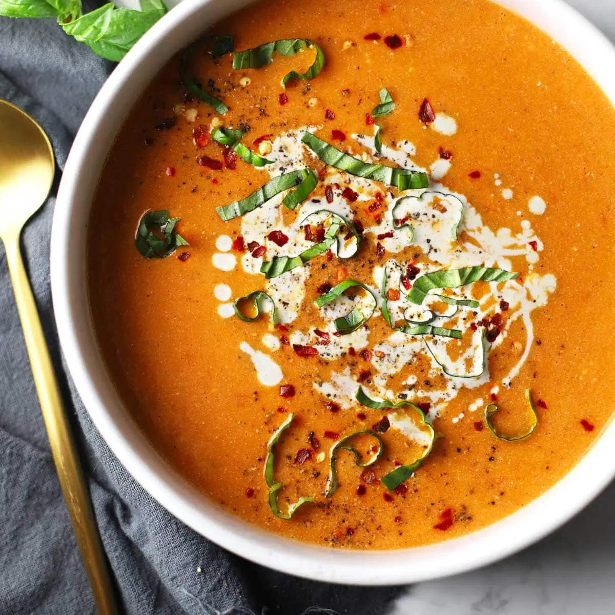 Roasted tomato soup in a white bowl.