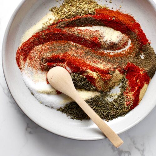 Cajun seasoning spices on a grey plate.