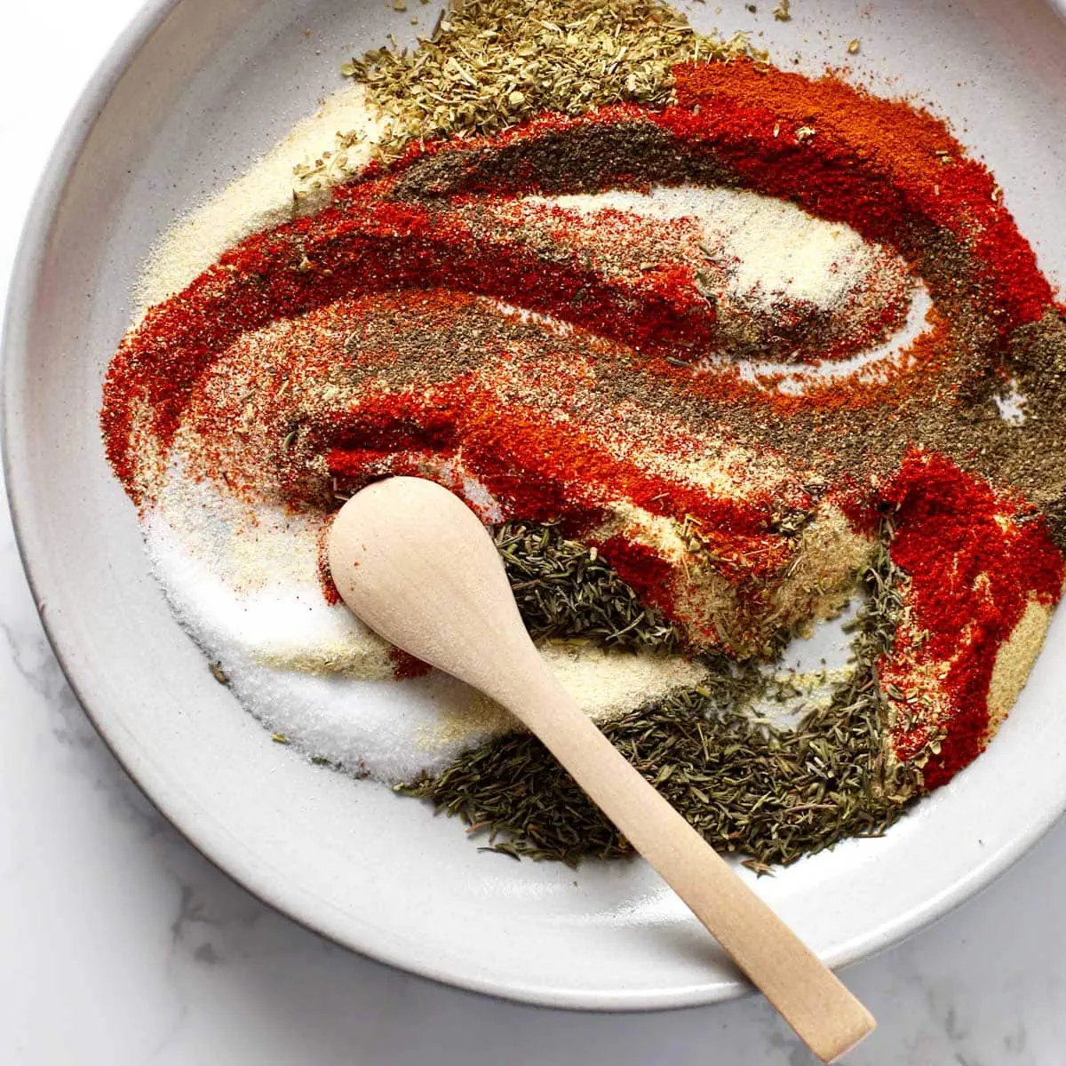 Cajun seasoning spices swirled together on a plate.