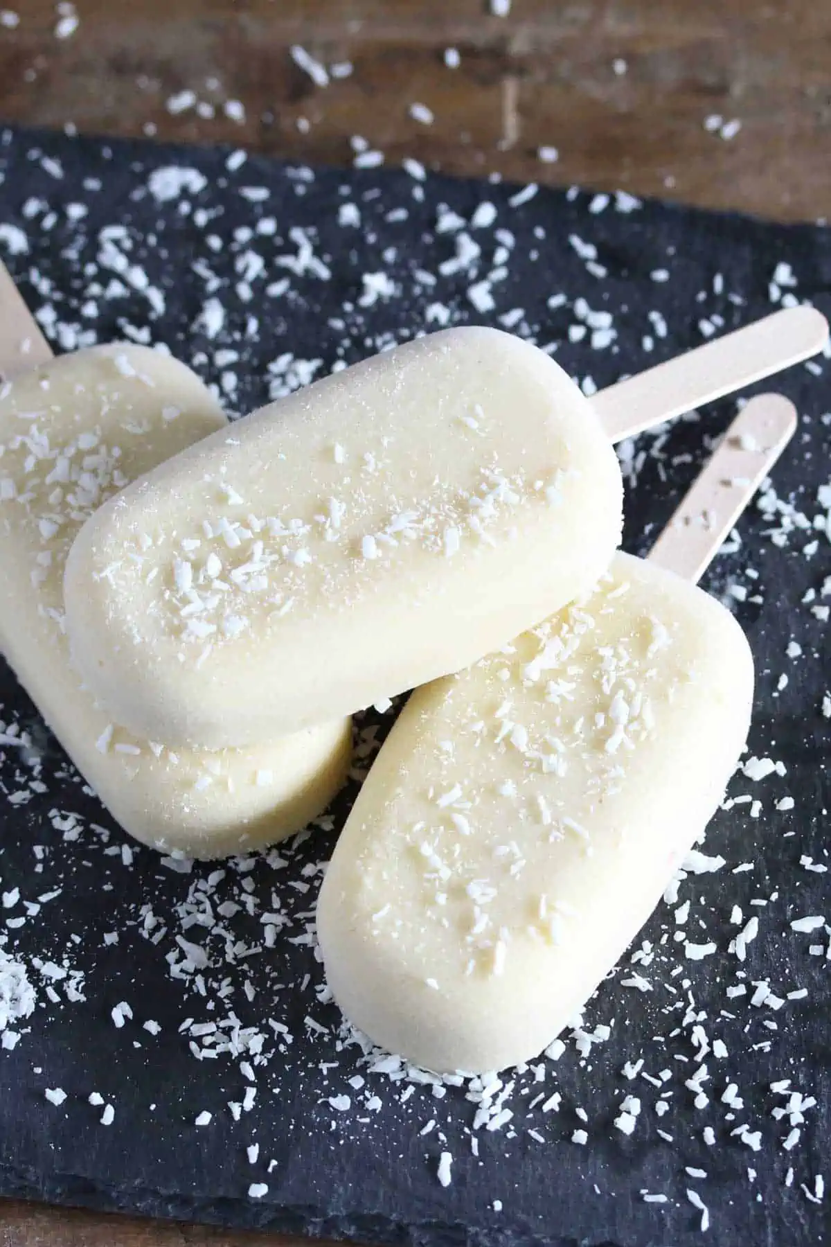 Three popsicles on grey serving platter.