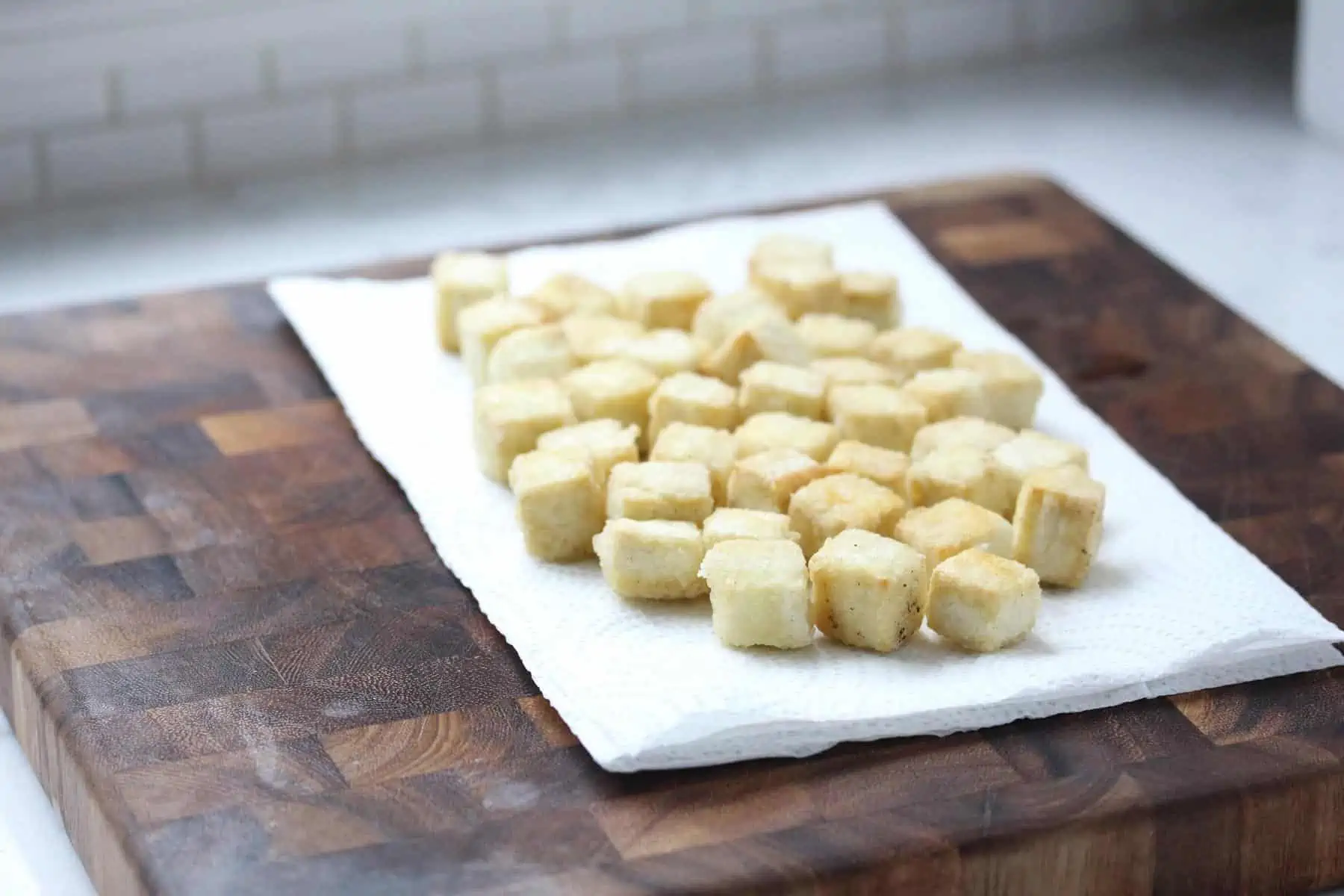 Crispy tofu on cutting board.