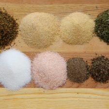 Spices on wood cutting board.