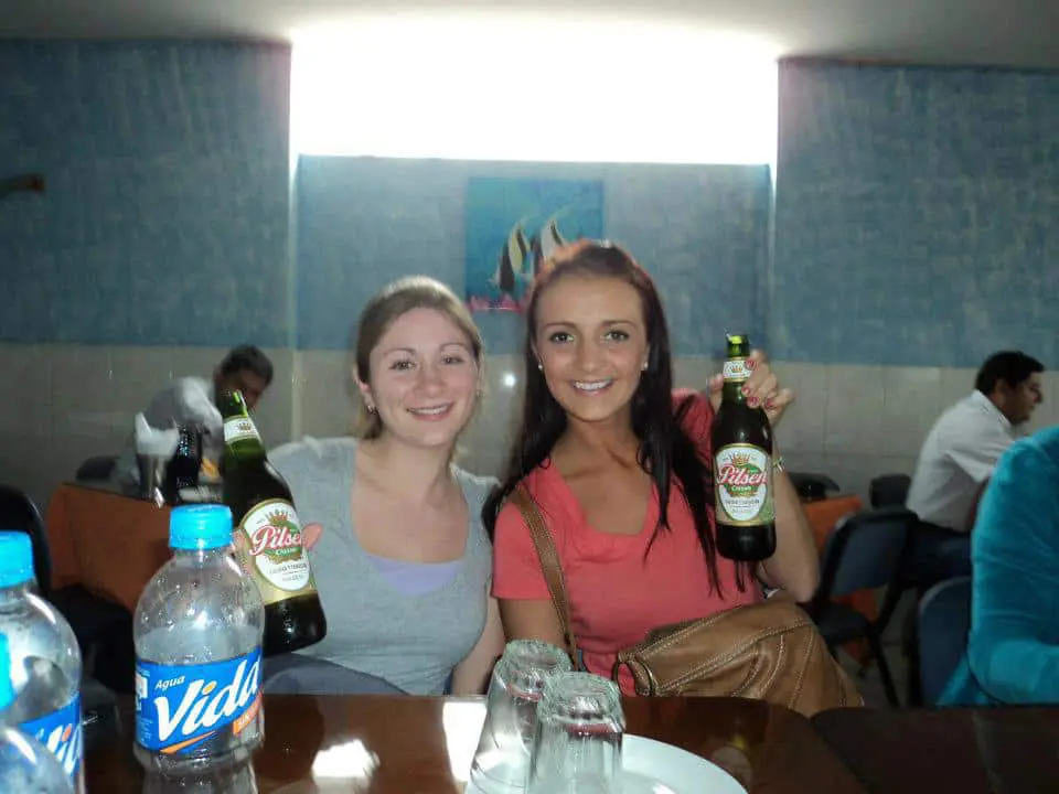 Two women holding beers.