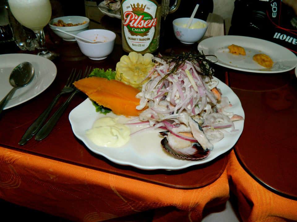 Fish salad and sweet potato on white plate.