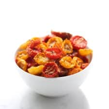 Slow roasted cherry tomatoes in white bowl.